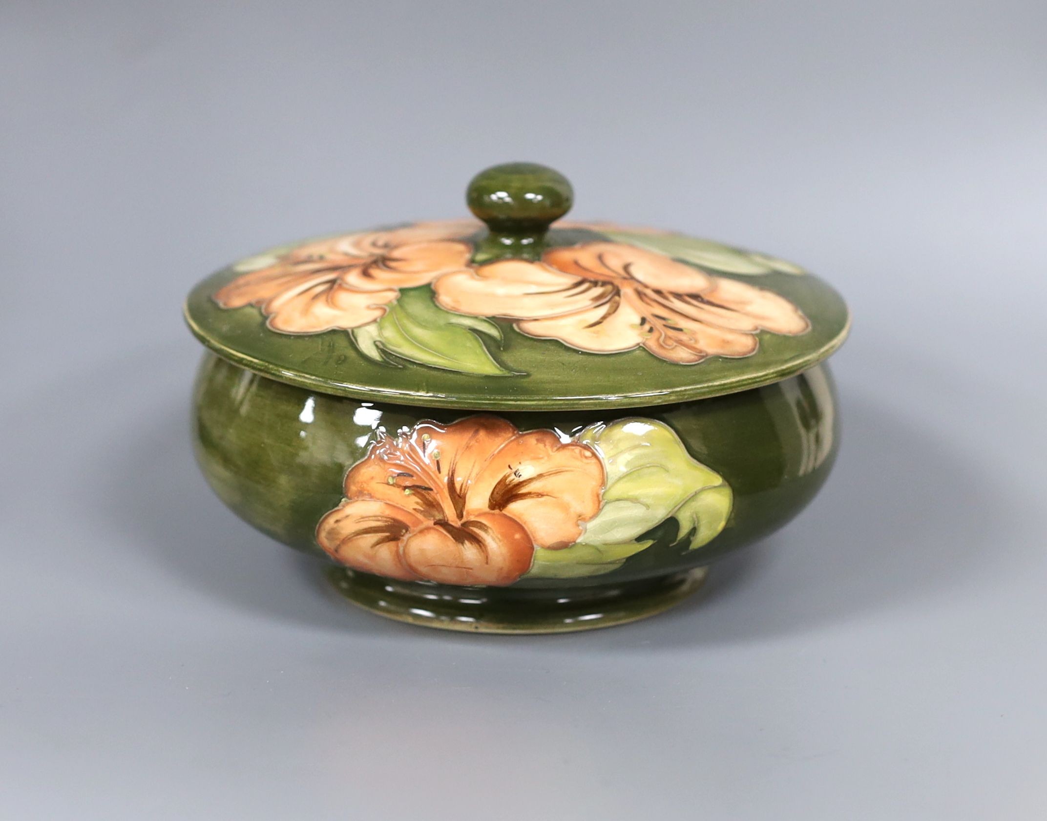 A Moorcroft powder bowl and cover, Hibiscus pattern, 15cm diam.